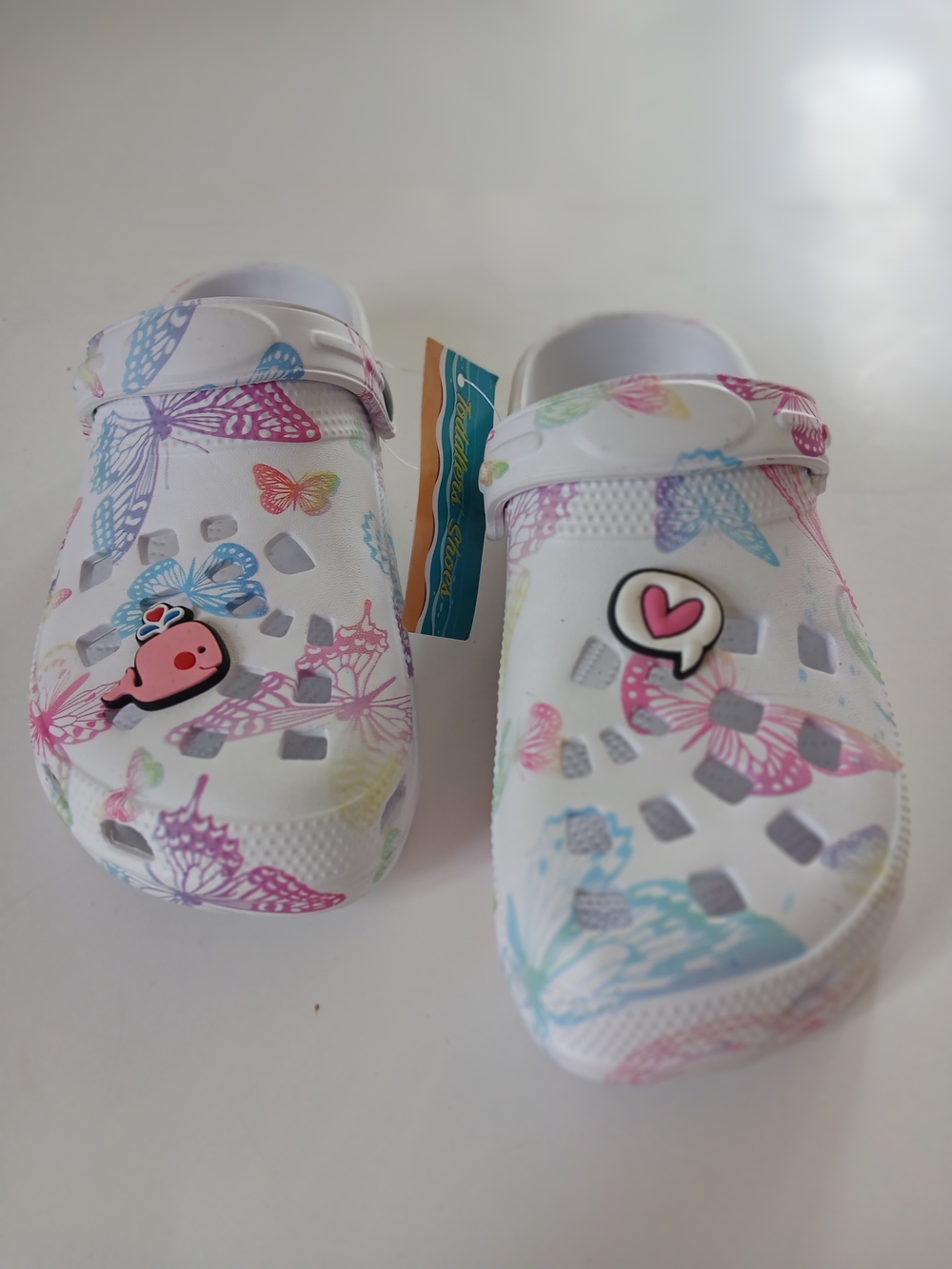 Kids White Butterfly Clogs with Pastel Accents and Charm.